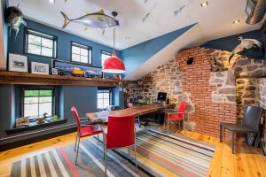 Office with fish on the ceiling and a brick and stone wall