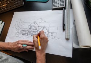 Person Drawing the Exterior of a New Custom Home