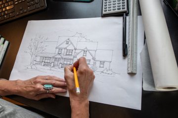 Person Drawing the Exterior of a New Custom Home