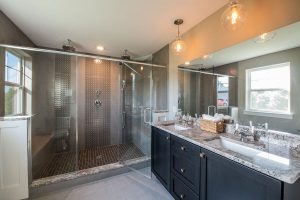 Full bathroom with massive shower that has two shower heads