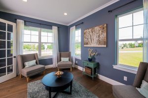 Family room with three chairs and blue walls