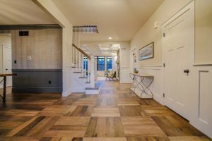 Front entrance of the modern farmhouse with hardwood floors