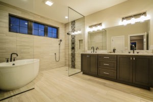 Full bathroom with two sinks and separate shower and tub