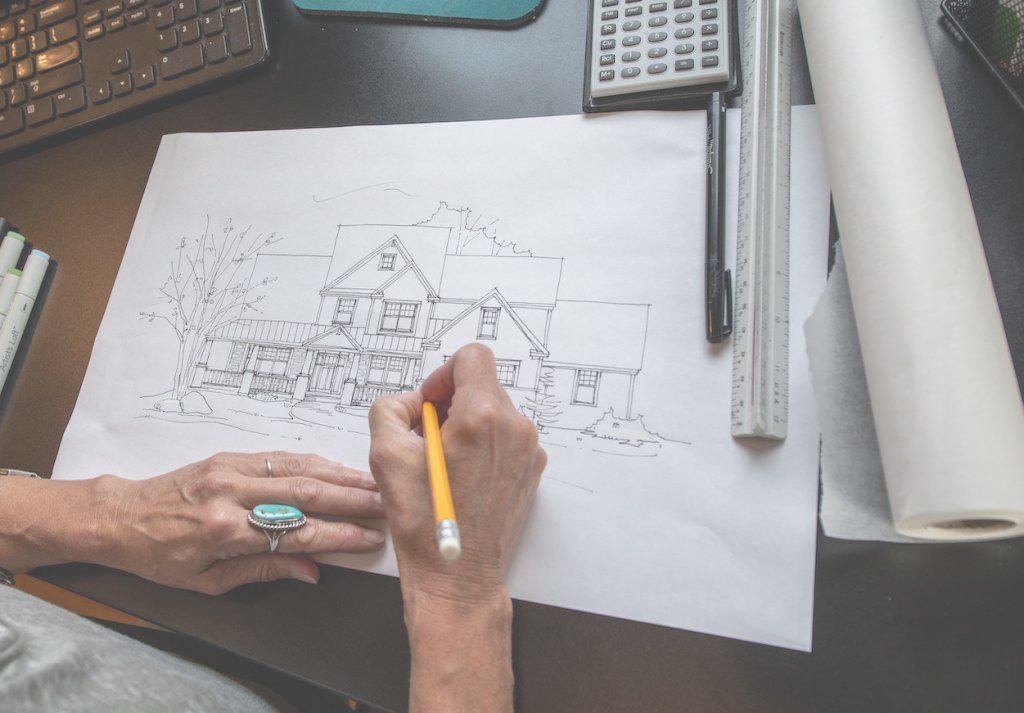 Drawing A Custom Home With Pencil On A Sheet Of Paper