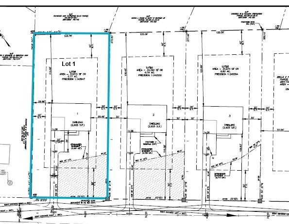 A black-and-white site plan with multiple property lots; Lot 1 is outlined in blue on the left side, showing lot boundaries, structures, and various survey markings.