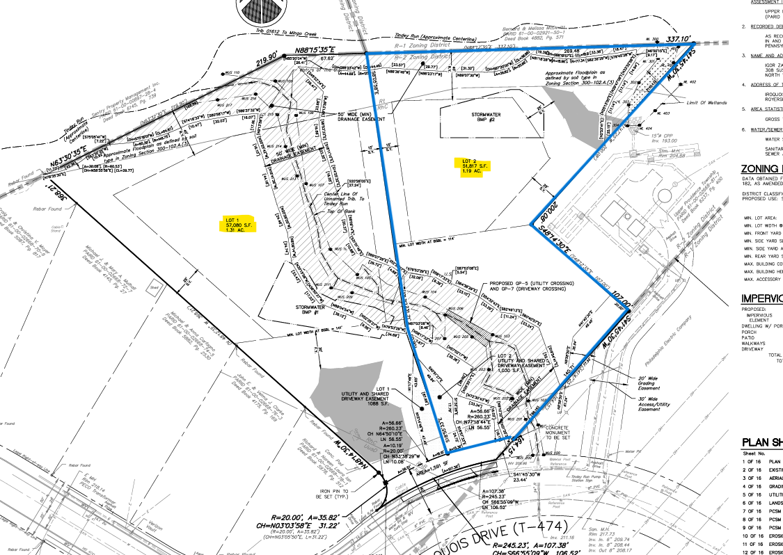 Site plan map with black and white zoning details, contour lines, and various boundary markers; two yellow-highlighted areas show labeled lot sections; a bold blue outline highlights a specific perimeter on the property.